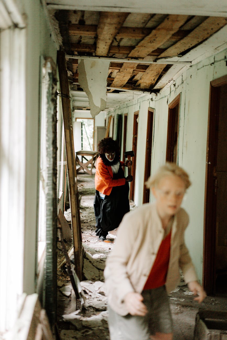 clown chasing a terrified boy on a hallway
